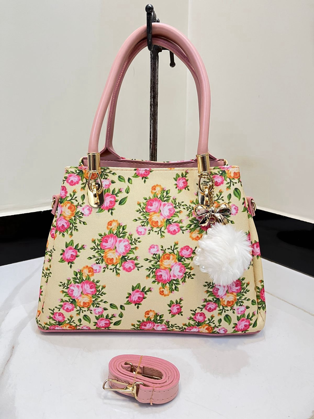 Elegant Floral Pattern Handbag with Stylish Handle and Charm Accent